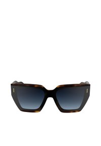 Gafas de sol hexagonales con montura de carey, lentes oscuros degradados y sutiles acentos dorados en los laterales.