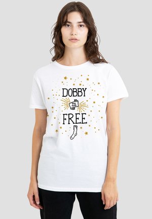 Woman wearing white t-shirt with "Dobby is Free" text, golden stars, a sock, and a book illustration on a plain light gray background.