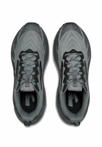 Gray athletic shoes with a textured mesh upper, black accents, and traditional lacing. Feature a cushioned sole and prominent branding.