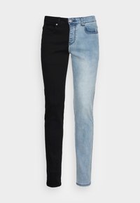 Skinny jeans featuring a split design: left side in solid black denim, right side in light blue faded denim, with classic five-pocket styling.
