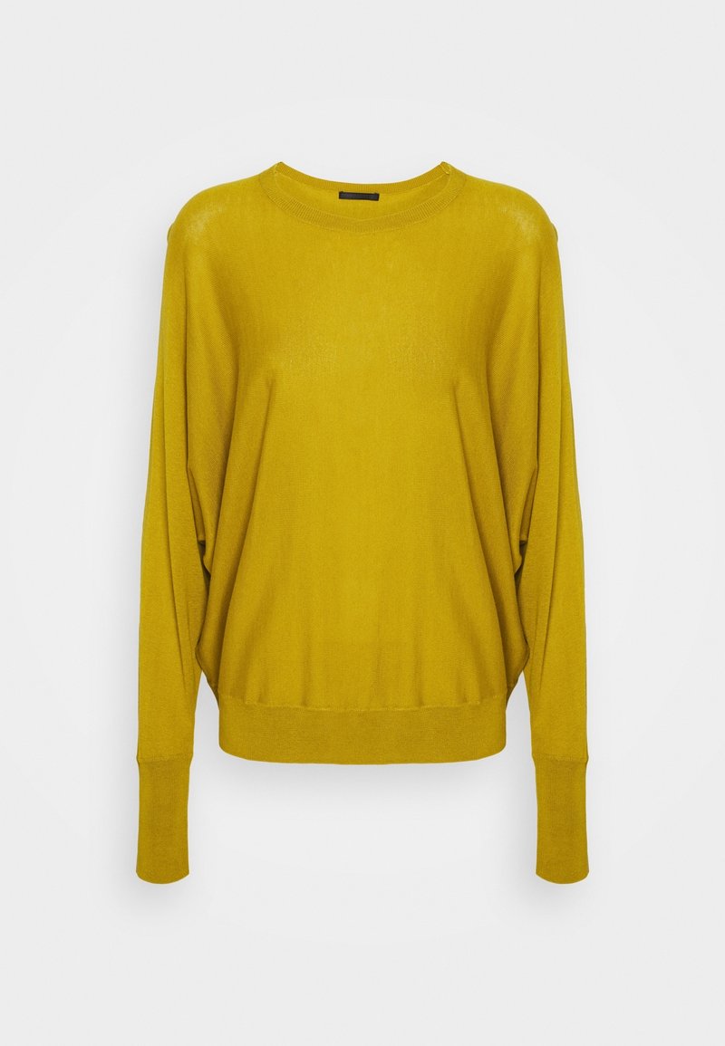 Maglione oversize in giallo senape con scollatura rotonda e lunghi maniche scese. Tessuto testurizzato con orlo e polsini a costine.