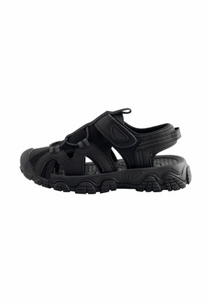 Black closed-toe outdoor sandal with adjustable straps, mesh side panels, and thick treaded sole designed for active wear.