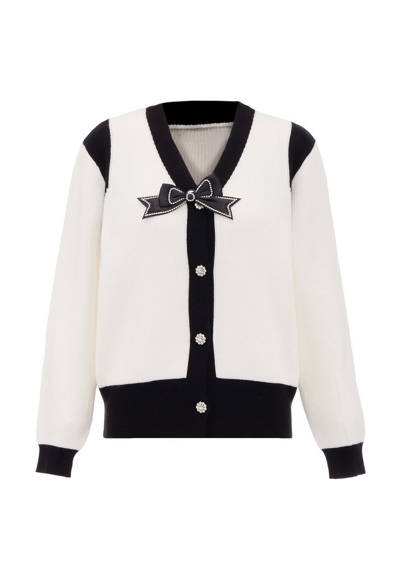 Cardigan rigato bianco e nero, con scollo a V profondo, un dettaglio con fiocco nero e perle, e sei chiusure decorative a pulsante.