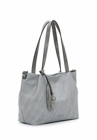 Gray fabric tote bag with two gray leather straps, a silver tassel accent, and a circular charm. Smooth texture and roomy design.