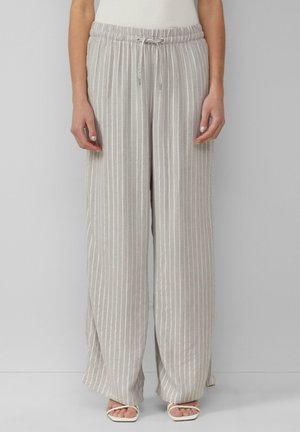 Light gray, wide-leg pants with vertical cream stripes, elastic waistband, drawstring detail, and a soft texture. Paired with light-colored sandals.