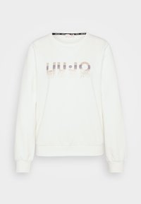 Felpa bianca, colletto rotondo, maniche lunghe a sbuffo, con un design di testo in gradiente violetto e oro con accenti a pois. Tessuto morbido.