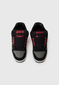 Black and gray athletic shoes with red accents, featuring a mesh upper, lace closure, padded tongue, and perforated toe box for ventilation.