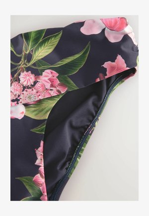 Plavky s tmavo námorníckym pozadím, zdobené kvetinovým vzorom v ružovej a zelenej farbe. Hladká látka s kontrastným prešitím.
