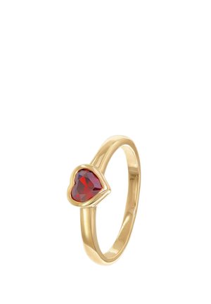 Gold ring with a heart-shaped red gemstone set in a smooth bezel on a plain band, shown against a white background.