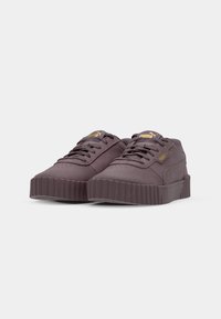 Lilla ruskind sneakers med en tykk ribbet sål, afrundet tå, snørebåndsdesign og gulllogo-detaljer.