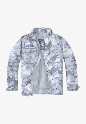 Szürke árnyalatú kamuflázs dzseki texturált polárral bélelve. Két mellzseb, magas gallér és cipzáras záródás jellemzi.