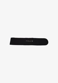 Chouchou en tissu noir, de forme rectangulaire allongée avec des bords arrondis, arbore le logo argenté "REMINGTON", texture lisse.