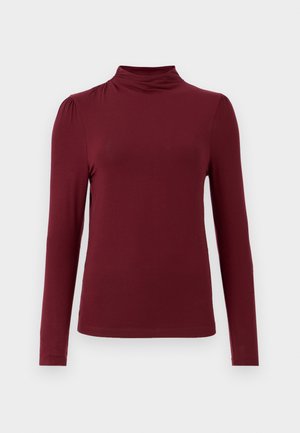 Bordeauxfarbenes langärmliges Oberteil mit einem Stehkragen, glatter Textur, dezenten Schulterfalten und figurschmeichelndem Schnitt. Hergestellt aus elastischem Material.