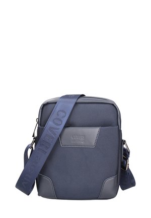 Borsa a tracolla compatta blu navy con tracolla regolabile, tessuto strutturato e etichetta "Coveri active" in rilievo sulla tasca frontale.