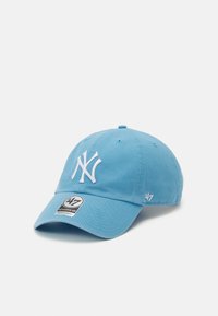Light blue cotton baseball cap featuring white embroidered NY logo, adjustable strap, and branded tag on the visor.