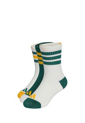 Trois paires de chaussettes blanches montantes avec des orteils et talons verts, des rayures vertes et jaunes en haut, et de petits motifs triangulaires sur les orteils.