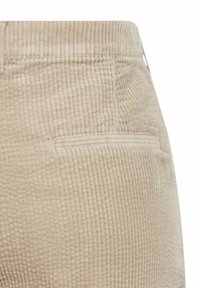Beige corduroy pants featuring vertical ribbed texture, a back pocket, and a waistband; fabric is soft and durable.