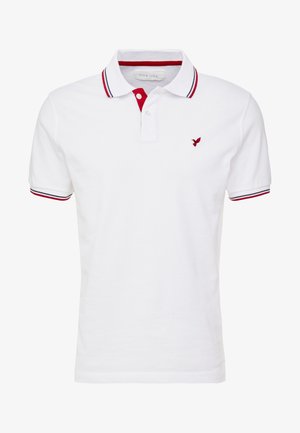 Witte polo met rode en marineblauwe accenten op de kraag en mouwen. Beschikt over een klein rood vogellogo op de linkerborst. Gemaakt van katoen.