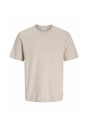 T-shirt beige en coton à manches courtes et col rond avec une petite étiquette de marque à l'encolure et à la couture latérale.