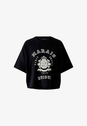 Sweat-shirt noir court avec un emblème de blason blanc et le texte "Marais Paris France 1972 Oui Oui" sur le devant, manches courtes, col rond.