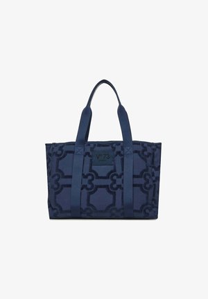 Bolso tote azul marino con patrón geométrico, dos asas largas y una etiqueta cuadrada en el centro frontal que dice "V°73 Venezia".