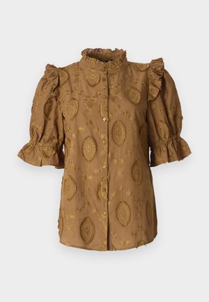 Blouse marron avec manches ballon, col volanté et motifs floraux en relief. Fermeture à boutons sur le devant ; tissu doux et texturé.