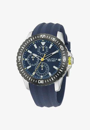 Nautica kronograafi kell sinise silikoonist rihmaga, ümmargune roostevabast terasest korpus, sinine kellaplaat, hõbedased detailid ja kollane accents kroonil.