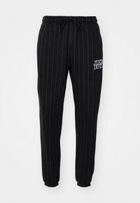 CLUB - Tracksuit bottoms - black/white