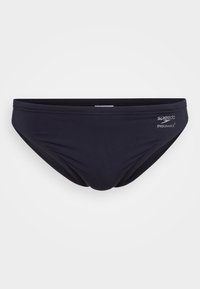 Fekete Speedo Endurance+ úszóshort minimális varrással egy sima világos háttér előtt.
