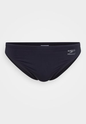 Black Speedo Endurance+ swim briefs with minimal stitching on a plain light background.