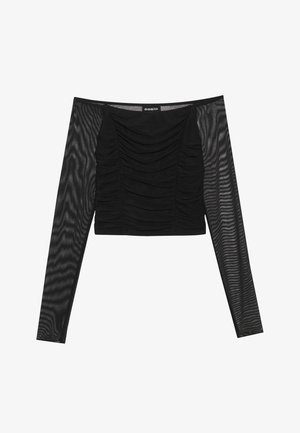 Svart långärmad topp med en rynkad front, en solid bodice och genomskinliga, texturerade ärmar. Naturlig halsringning och en figursydd design.
