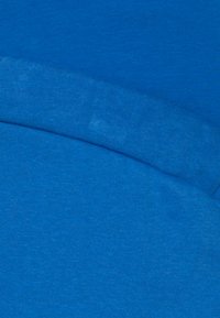 Bright blue fabric featuring a smooth texture, with two overlapping sections showing variations in shade and texture.