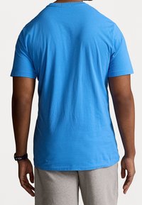 Blue cotton t-shirt with a round neckline and short sleeves. Smooth texture and a relaxed fit. No visible patterns or accents.