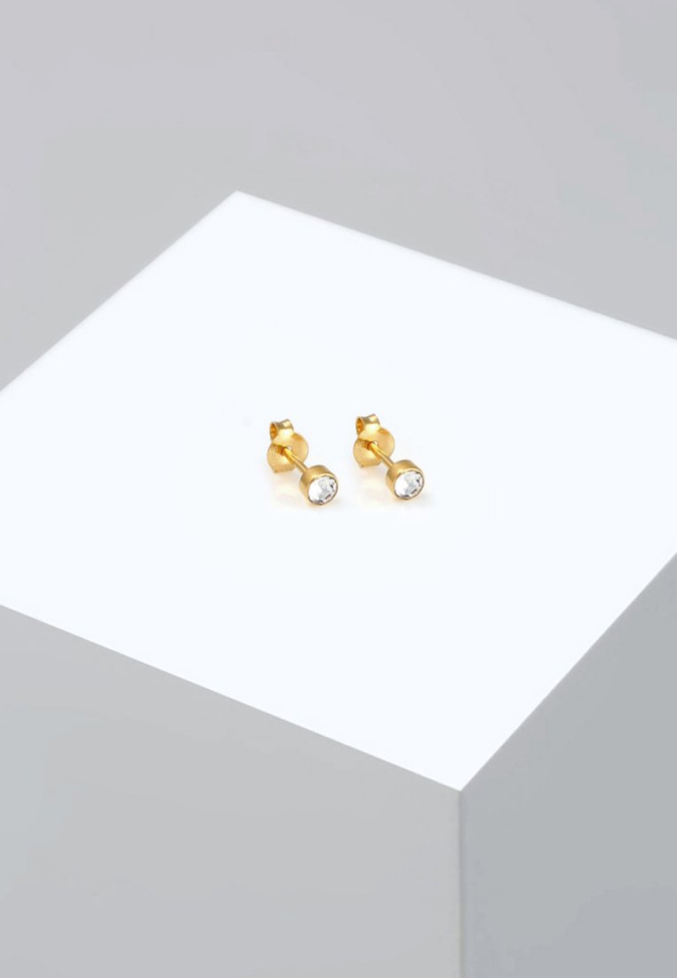 Zlatne metalne naušnice s čistim okruglim rhinestones, dizajnirane s glatkom površinom i jednostavnim geometrijskim oblikom.