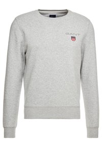 Grijze sweatshirt gemaakt van zacht katoenmixstof, met een ronde hals, geribbelde manchetten en zoom, en een klein geborduurd logo met schilddetail.
