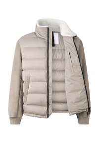 Beige polstret jakke med en blød krave, med lynlås foran, sidelommer og en kombination af bløde teksturer og materialer.