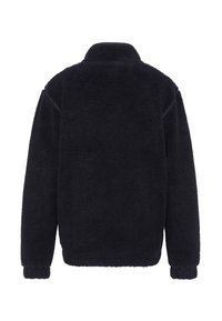 Giacca in pile blu navy scuro con collo alto, superficie testurizzata e polsini elastici, caratterizzata da una vestibilità comoda e senza chiusure visibili.