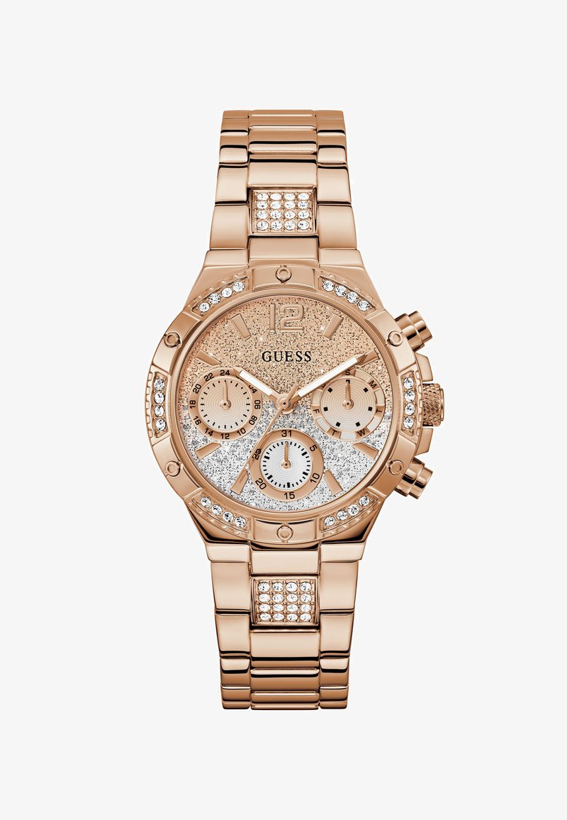 Rose gold Guess wristwatch with glitter dial, crystal accents on bezel and bracelet, three subdials, and metal link strap.