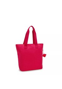 Borsa tote in tela rosa con maniglie corte e un dettaglio a pom-pom, caratterizzata da una forma rettangolare semplice e una texture liscia.