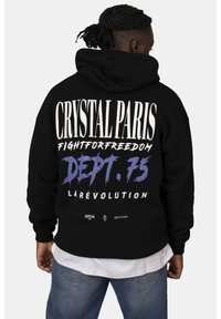 Felpa nera con cappuccio che presenta un audace testo bianco e viola sul retro, con le frasi “CRYSTAL PARIS” e “FIGHTFORFREEDOM”, tessuto testurizzato.