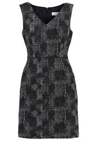 Robe fourreau sans manches en noir et blanc texturé avec décolleté en V et fermeture éclair au dos.