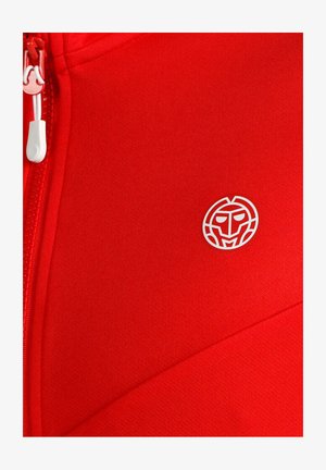 Tela roja brillante con una cremallera blanca y un pequeño logo de cara estilizada en blanco impreso en el lado derecho.