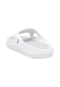 White slip-on sandal with a contoured design, open sides, textured insole, and a smooth outer surface. Features a logo accent on the side.