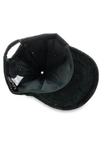 Black corduroy cap with a soft interior lining and ventilation eyelets, featuring a curved brim and stitched accents. Labels visible inside.