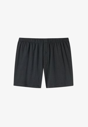 Zwarte onderbroeken van zachte stof, met een patroon van witte stippen, een elastische tailleband en een enkel knoopgulp.