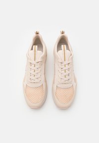 Light pink athletic shoes with mesh and synthetic upper, flat laces, and a textured rubber sole. Features decorative stripes on the tongue.