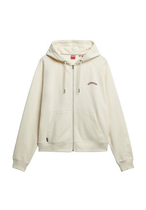 Hoodie crème zippé en matériau doux, avec une poche avant, une capuche à cordons et un logo "Superdry" brodé en rouge sur la poitrine.