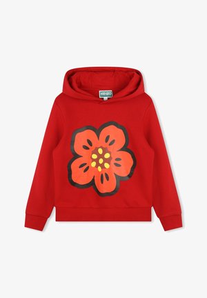 Sweat-shirt à capuche rouge présentant un grand motif de fleur orange stylisée avec des points jaunes, fabriqué à partir d'un tissu en coton doux.