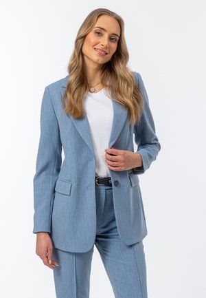 - Spodnie materiałowe