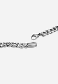 Silver metal chain bracelet with interlocking links, featuring a smooth finish and a secure lobster clasp closure.